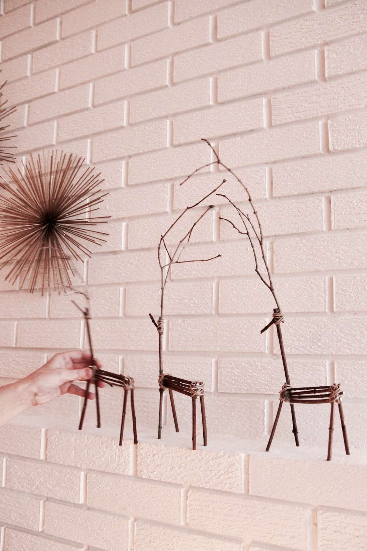 I love twig reindeer at christmas! They're such a cute christmas craft for a girls' night. They look so great on the christmas mantle too. Here's how to make your own twig reindeer! #twigreindeer #stickreindeer #diyreindeer #reindeermantle