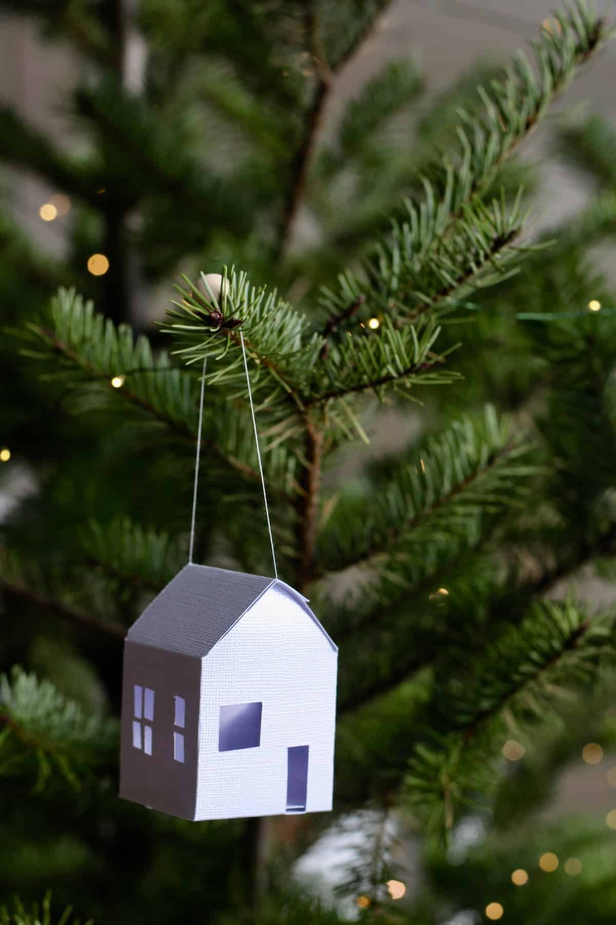 Paper house ornament on christmas tree