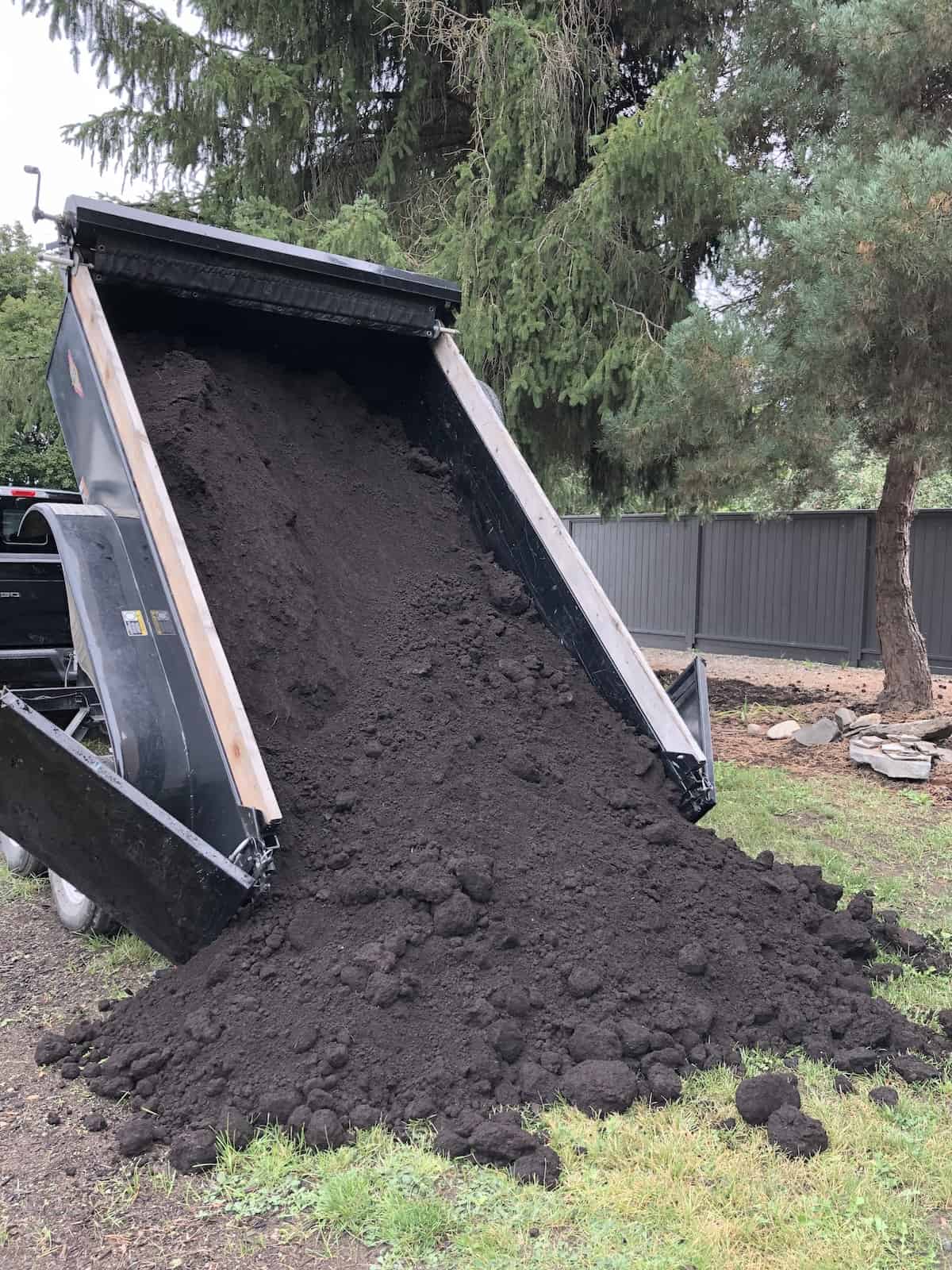 Omri-listed topsoil being delivered with dump trailer