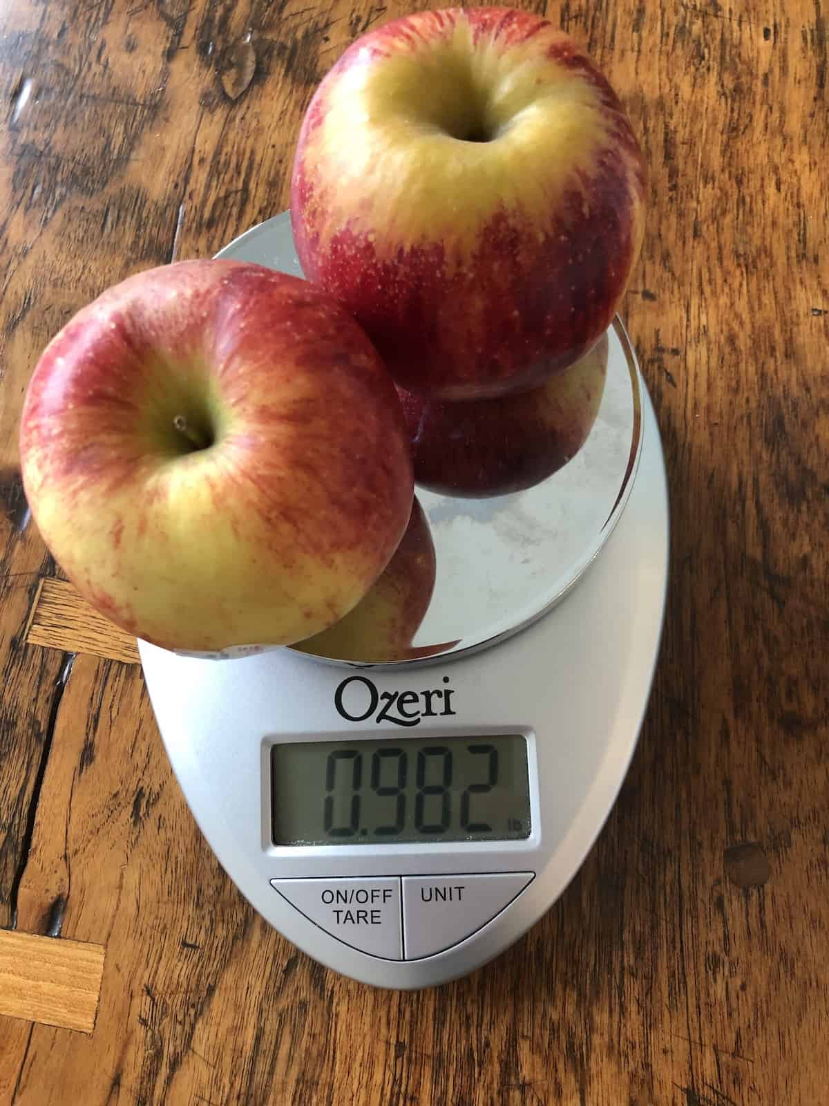 One pound of envy apples on a scale - weight shown
