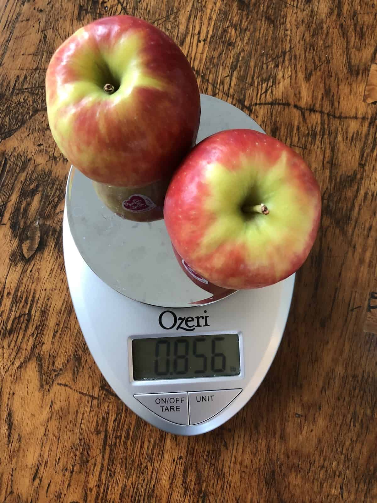 One pound of pink lady apples on a kitchen weigh scale