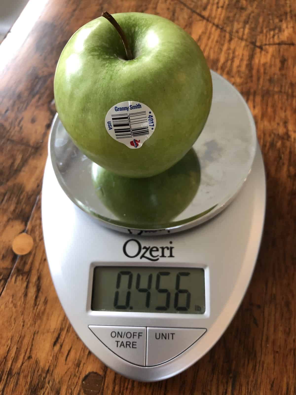 weighing a granny smith on a kitchen scale