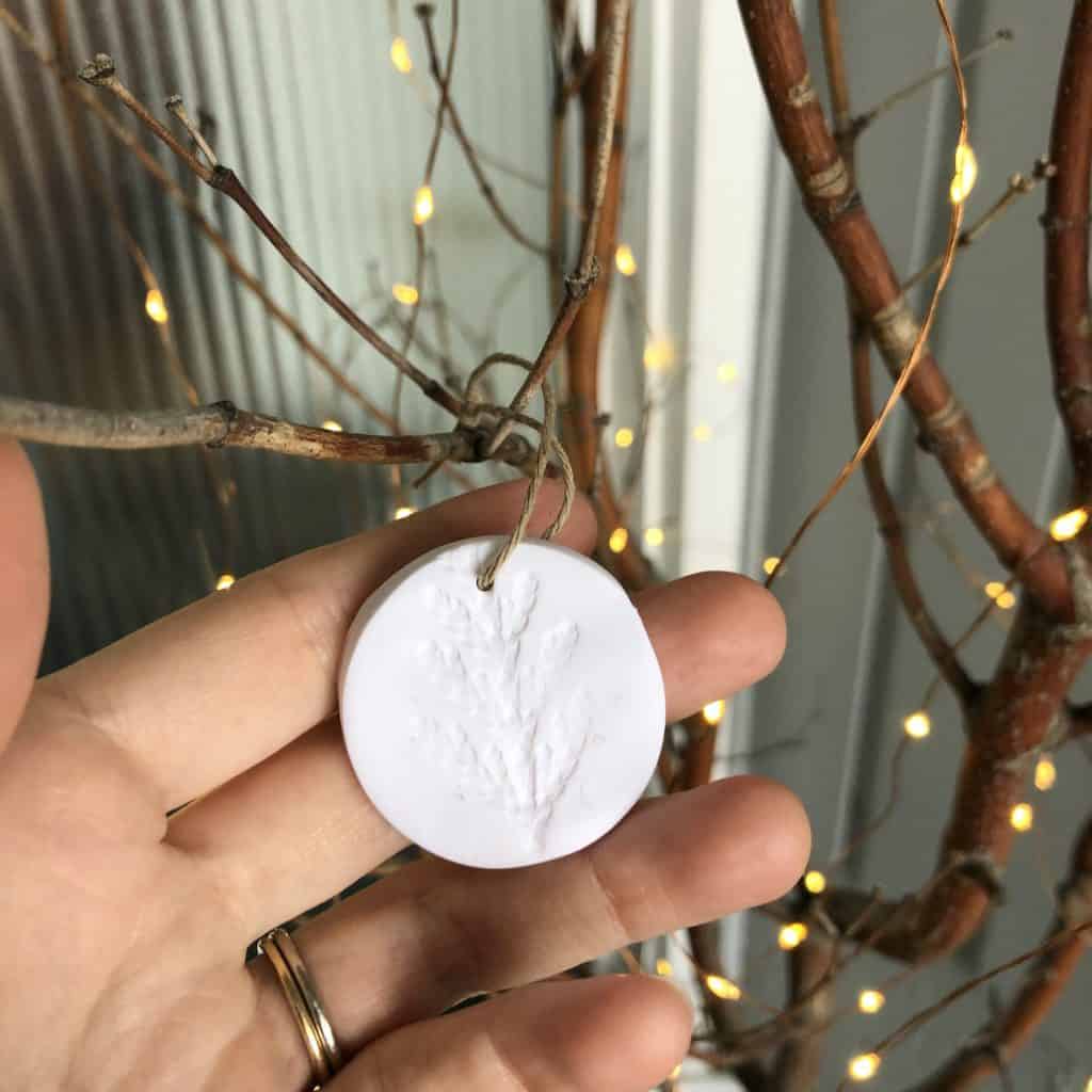 Diy polymer clay ornaments for the holidays on stick tree outside