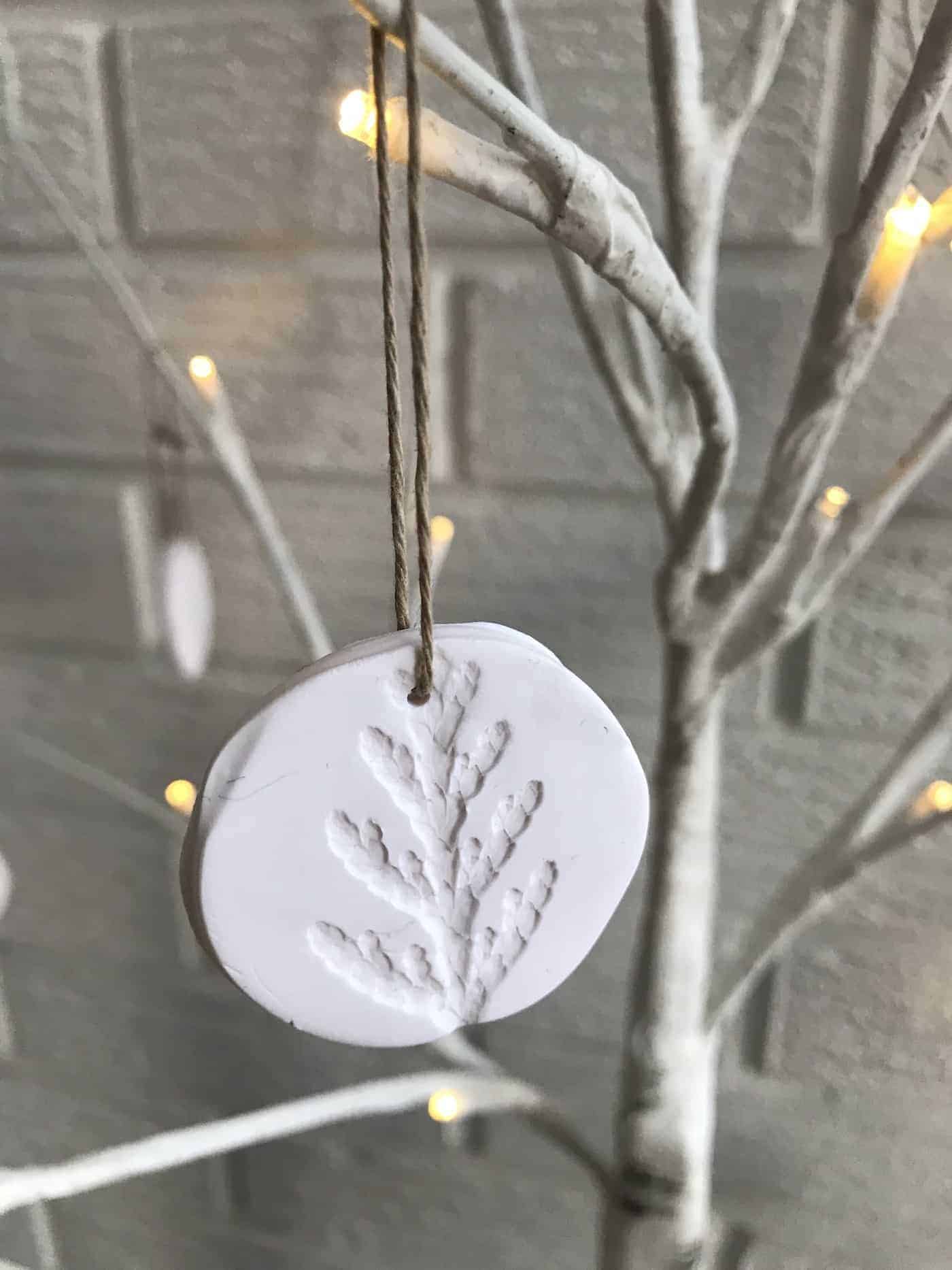 Polymer clay christmas ornaments on white birch tree branches