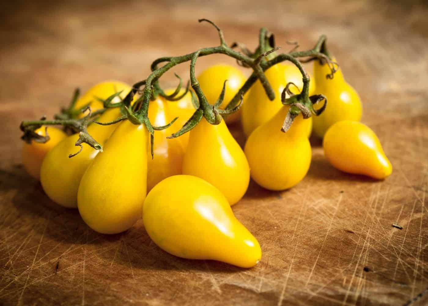 yellow pear tomatoes on cutting board
