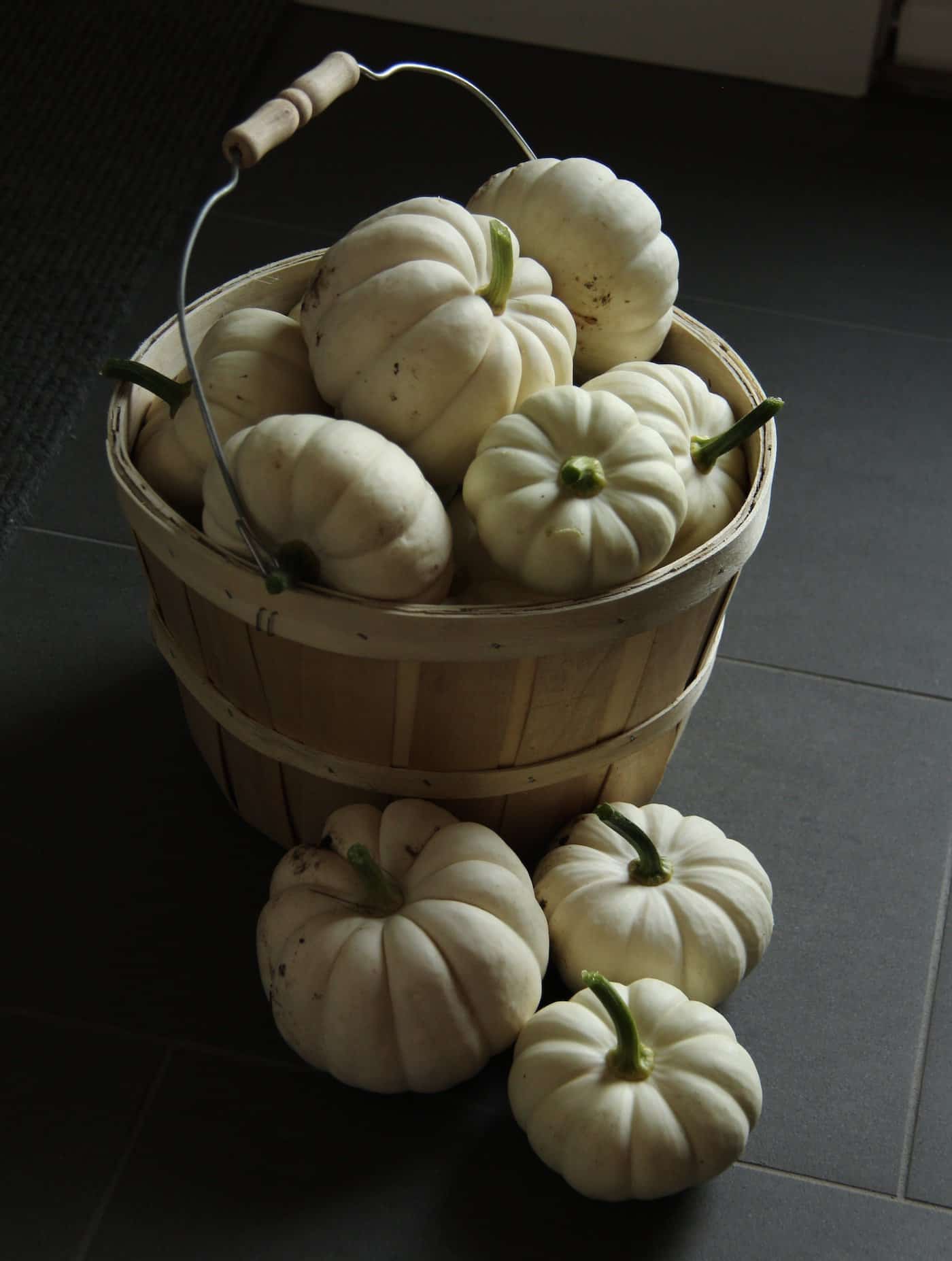 Casperita pumpkins in wooden bushel basket by the back door